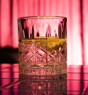 Close-up of swirling whiskey in a crystal glass with soft background lighting