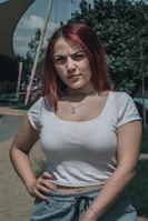 a woman with red hair is posing for a picture