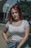 a woman with red hair is posing for a picture