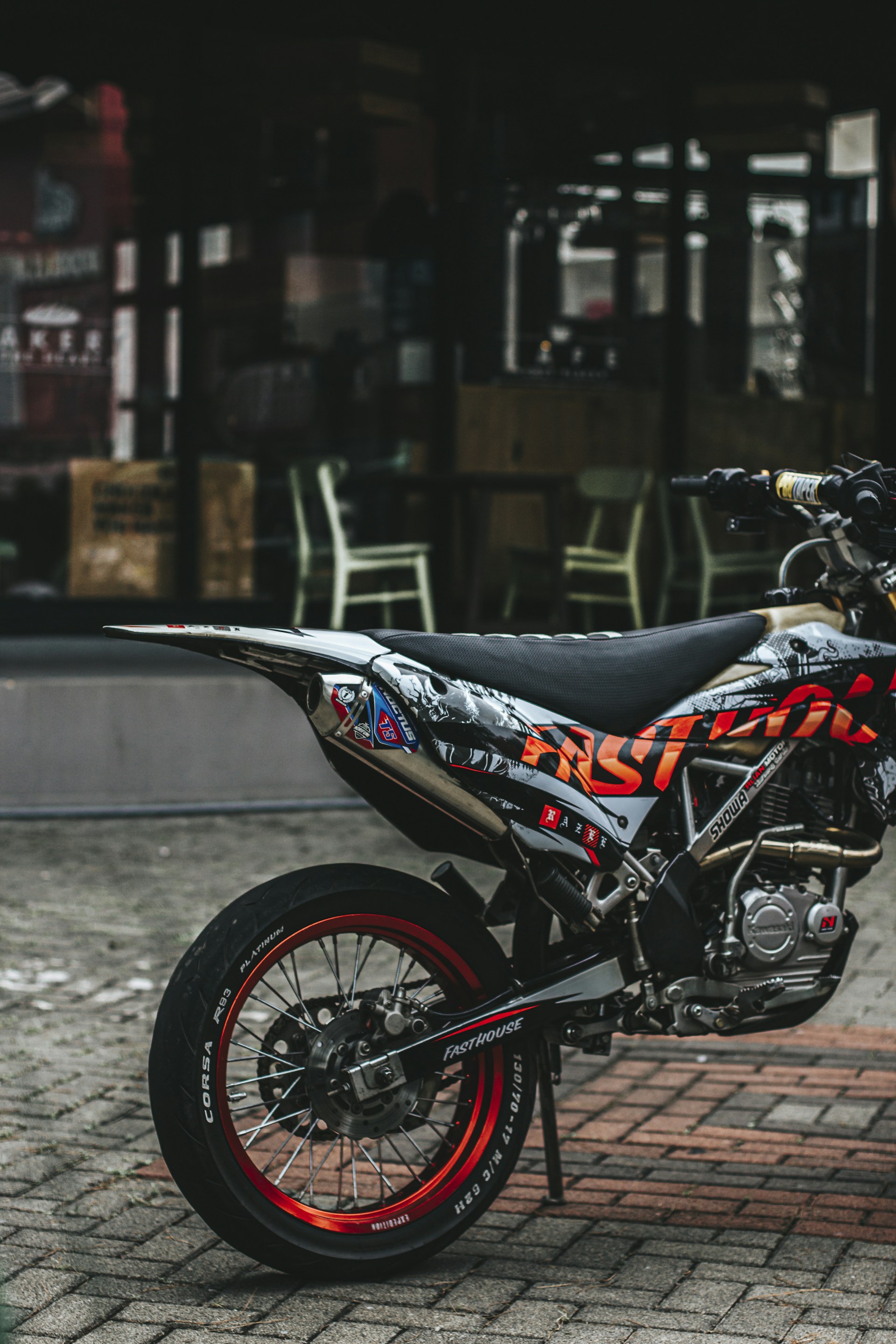 a dirt bike parked on a brick road