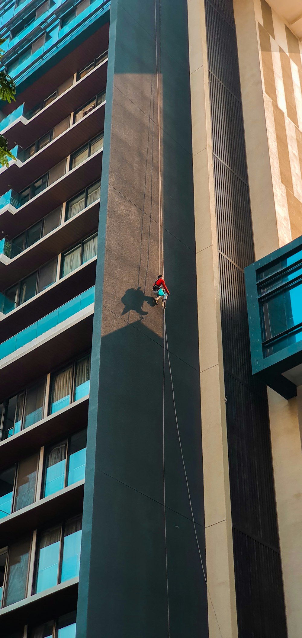 a man climbing up the side of a tall building