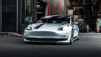 a silver sports car parked in front of a building