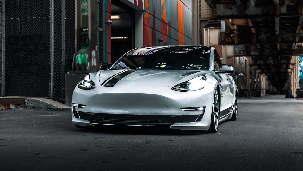 a silver sports car parked in front of a building