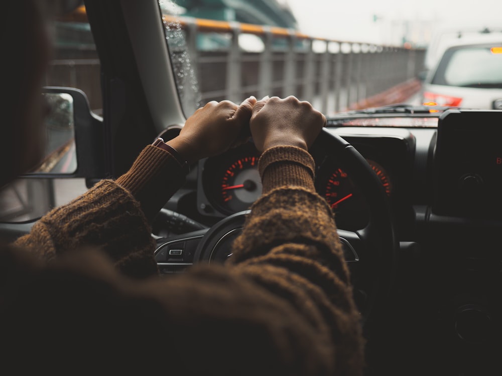 a person driving a car on a city street