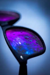 Close-up of sleek sunglasses designed for water sports with splash effects