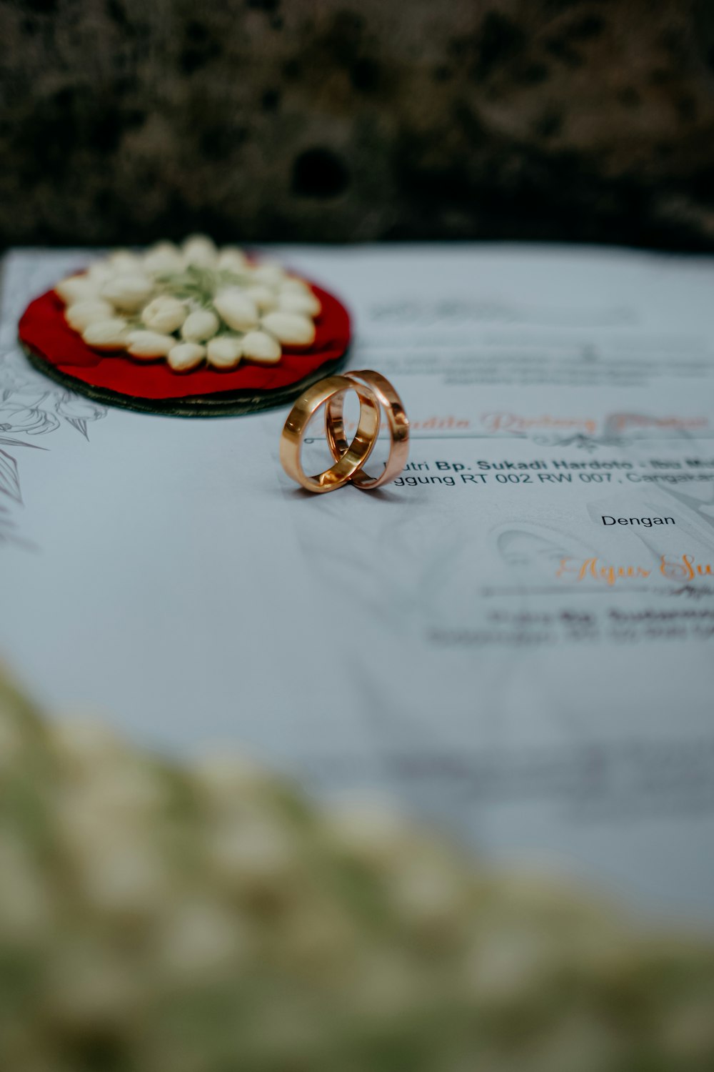 two wedding rings sitting on top of a piece of paper