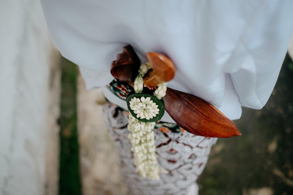 a close up of a person holding a flower