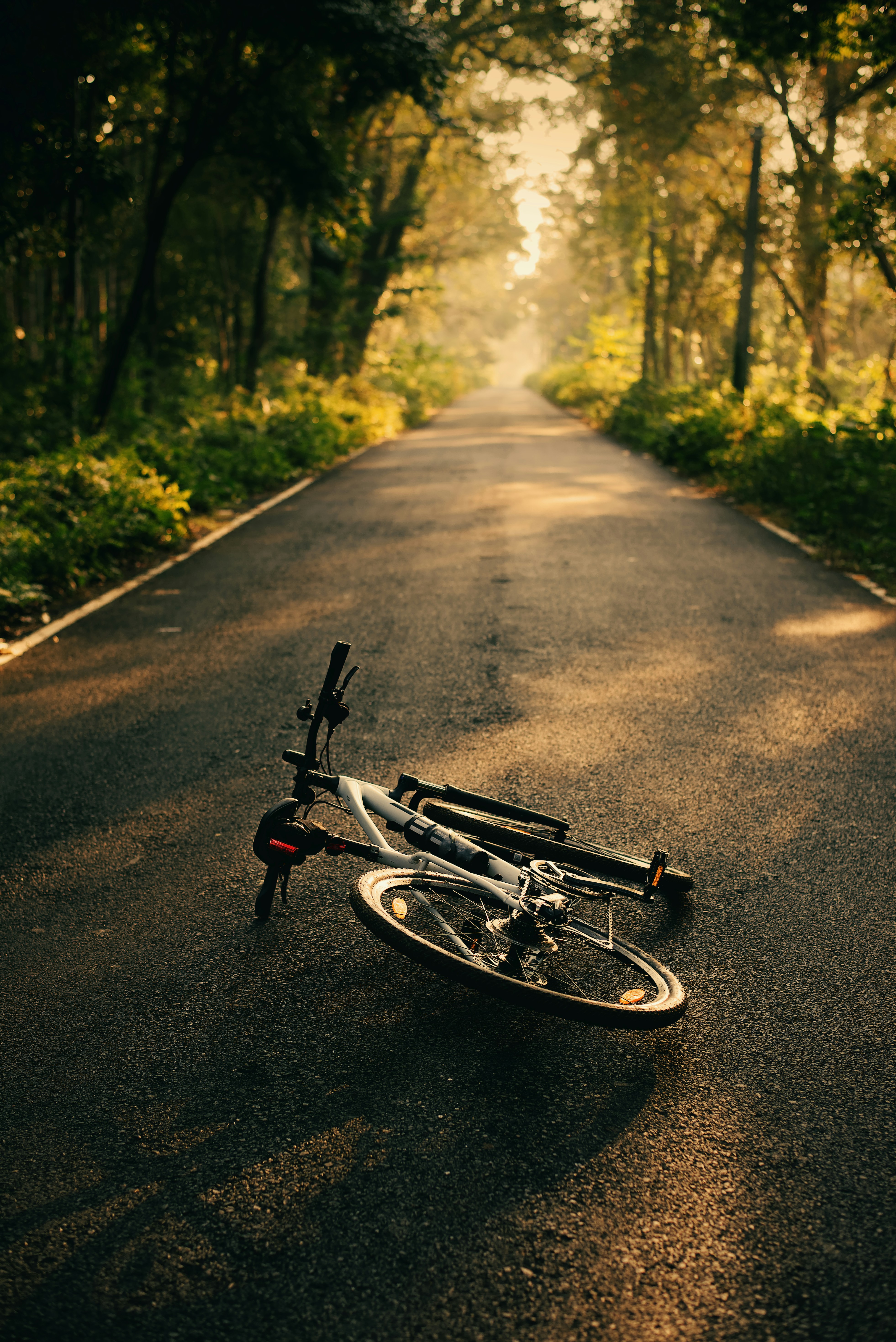 a bicycle laying on the side of a road