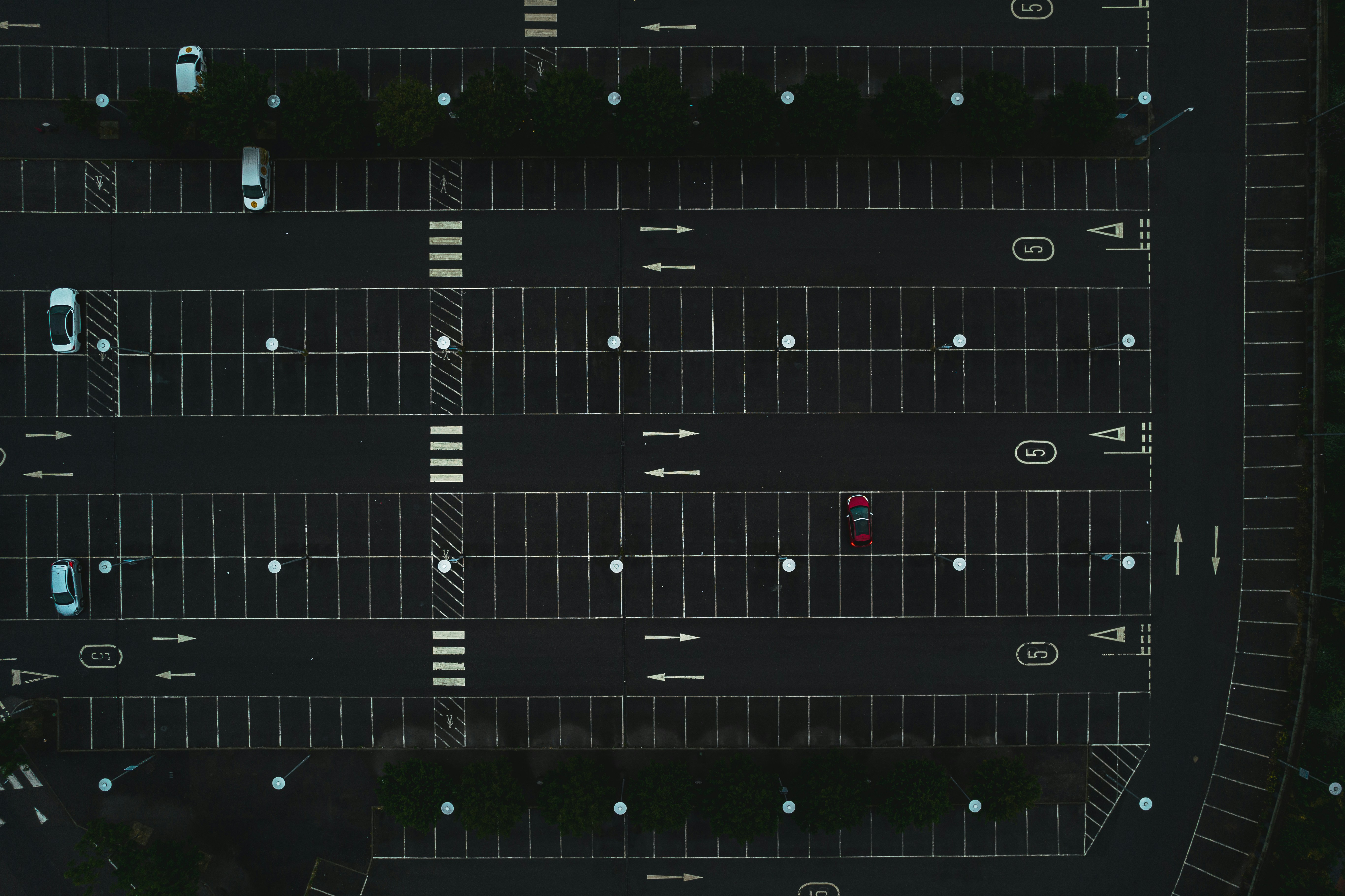 an overhead view of a parking lot at night