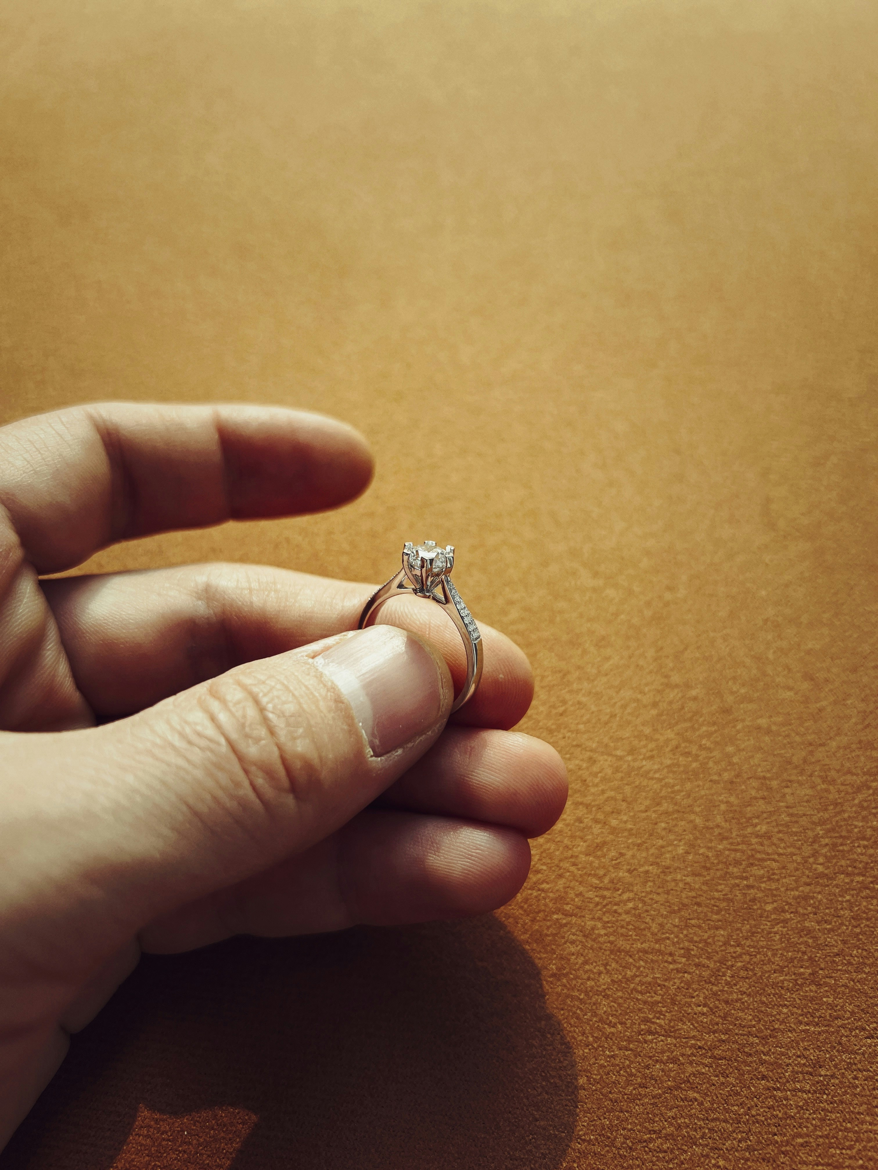 a person holding a ring in their hand