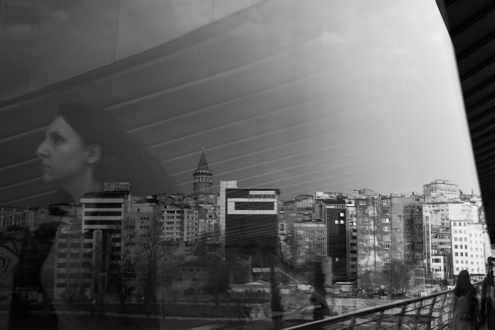 a woman looking out a window at a city