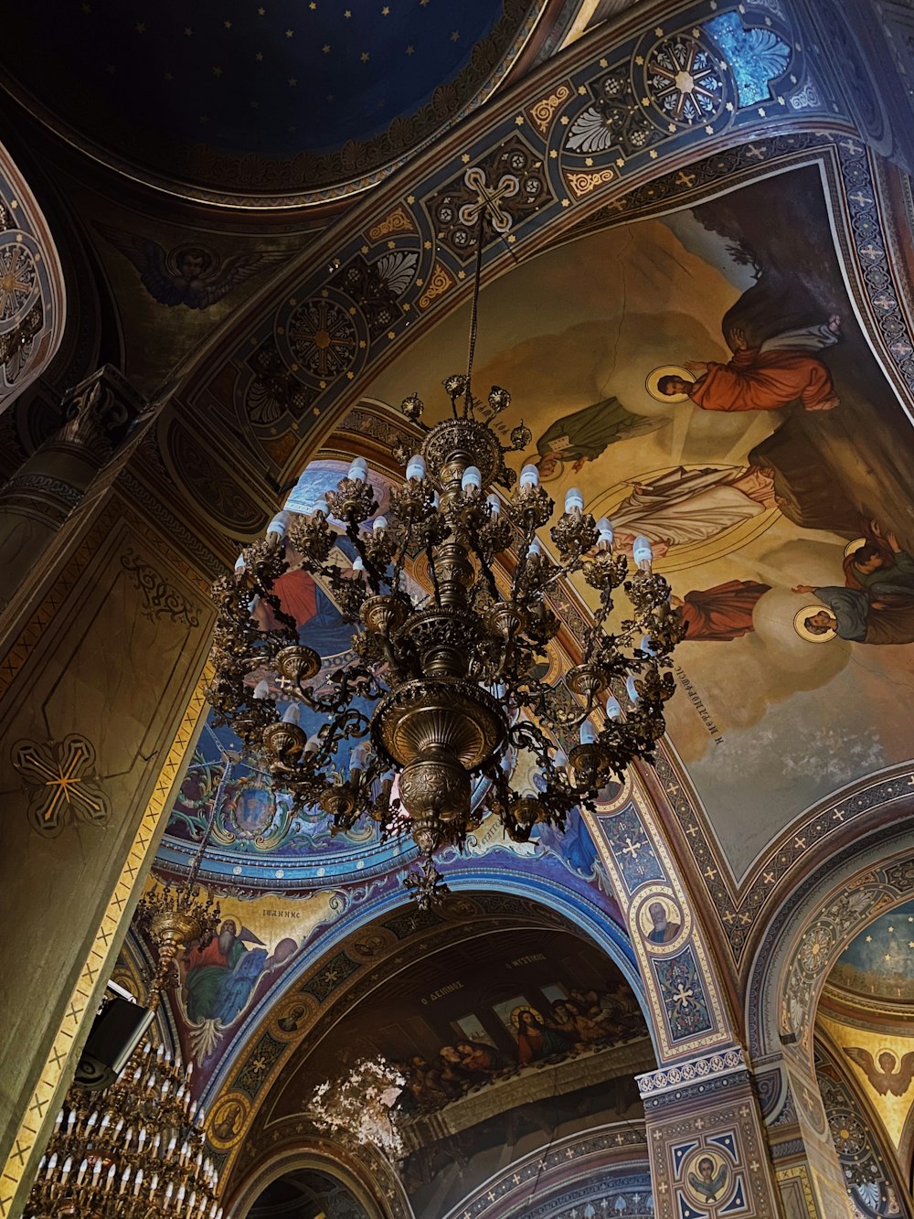 a chandelier hanging from the ceiling of a church