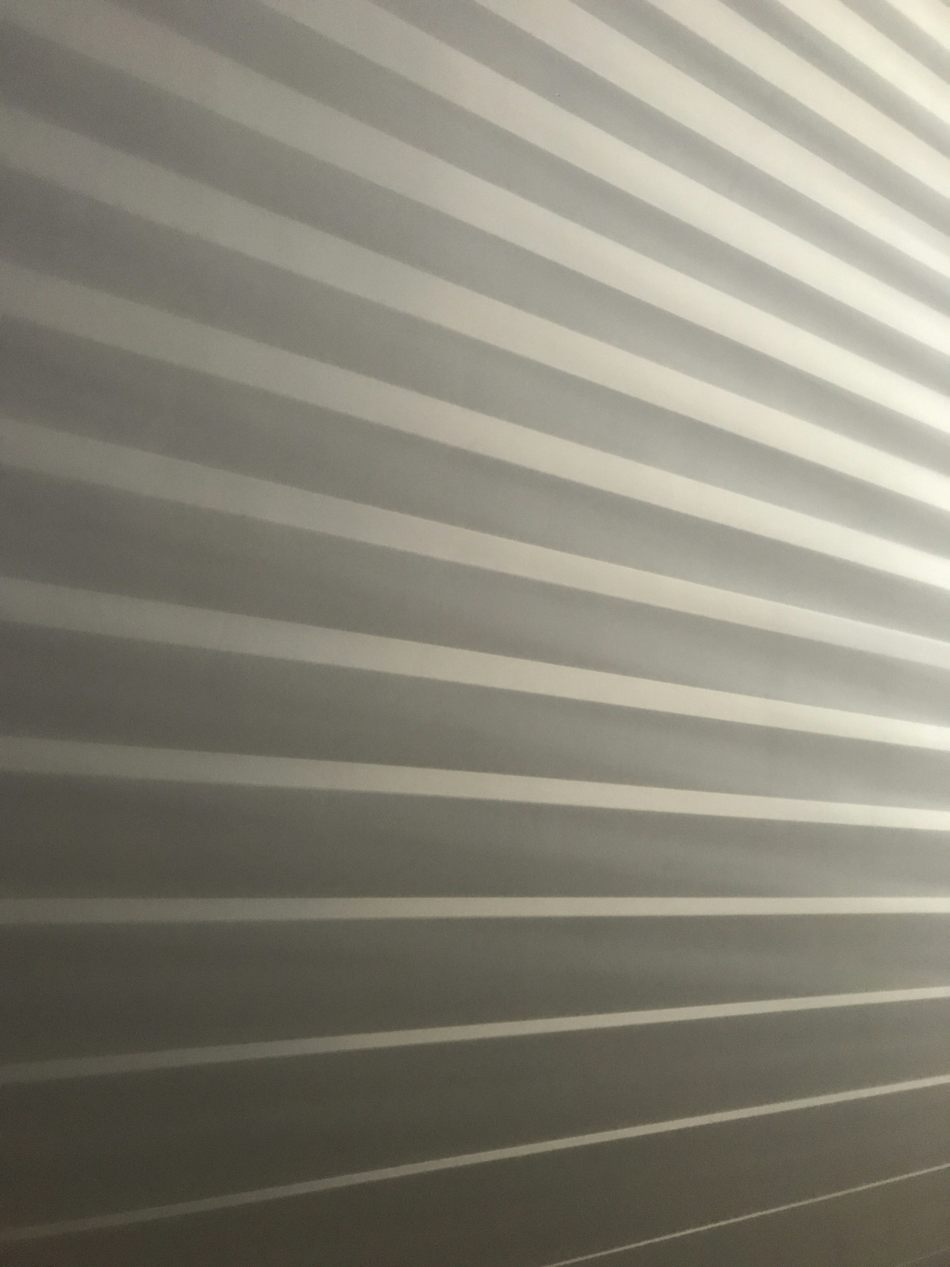 a room with a wall that has a striped pattern on it