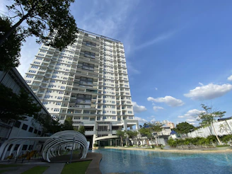 a very tall building next to a swimming pool