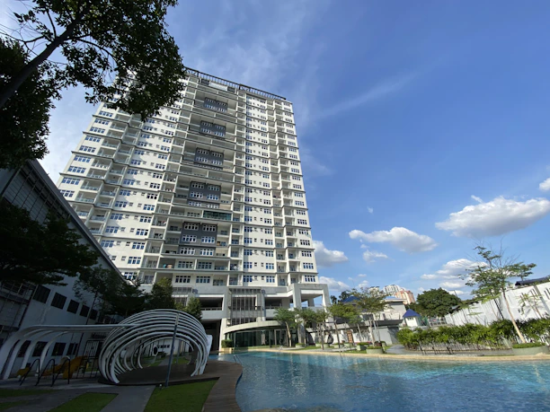 a very tall building next to a swimming pool