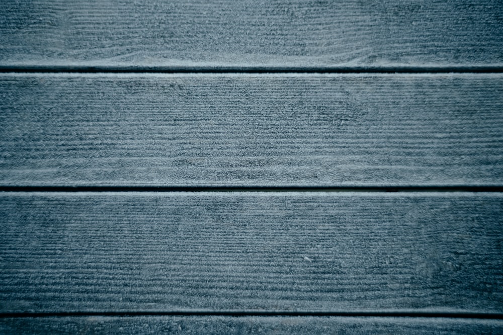 a close up of a wooden surface with blue paint