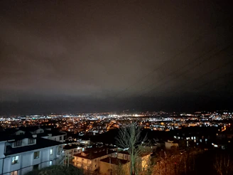 A nighttime cityscape with visible security lights.