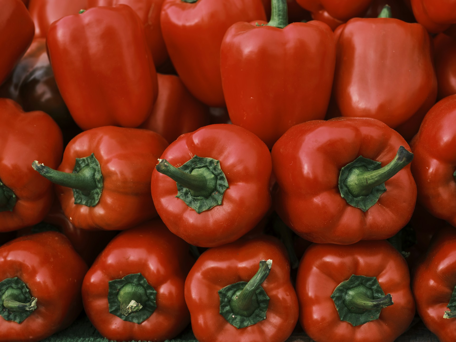 a pile of red peppers sitting on top of each other