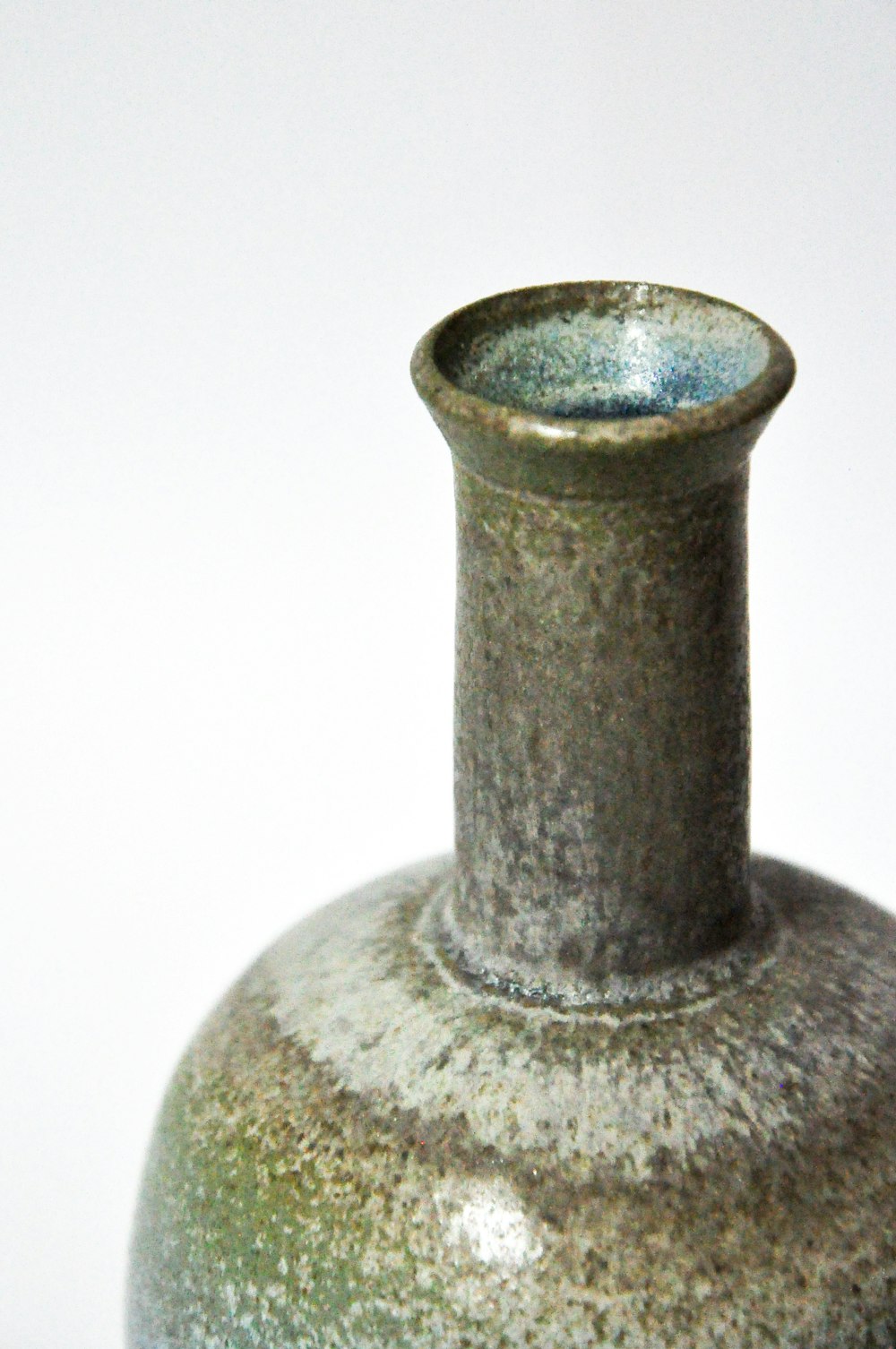 a gray vase sitting on top of a table