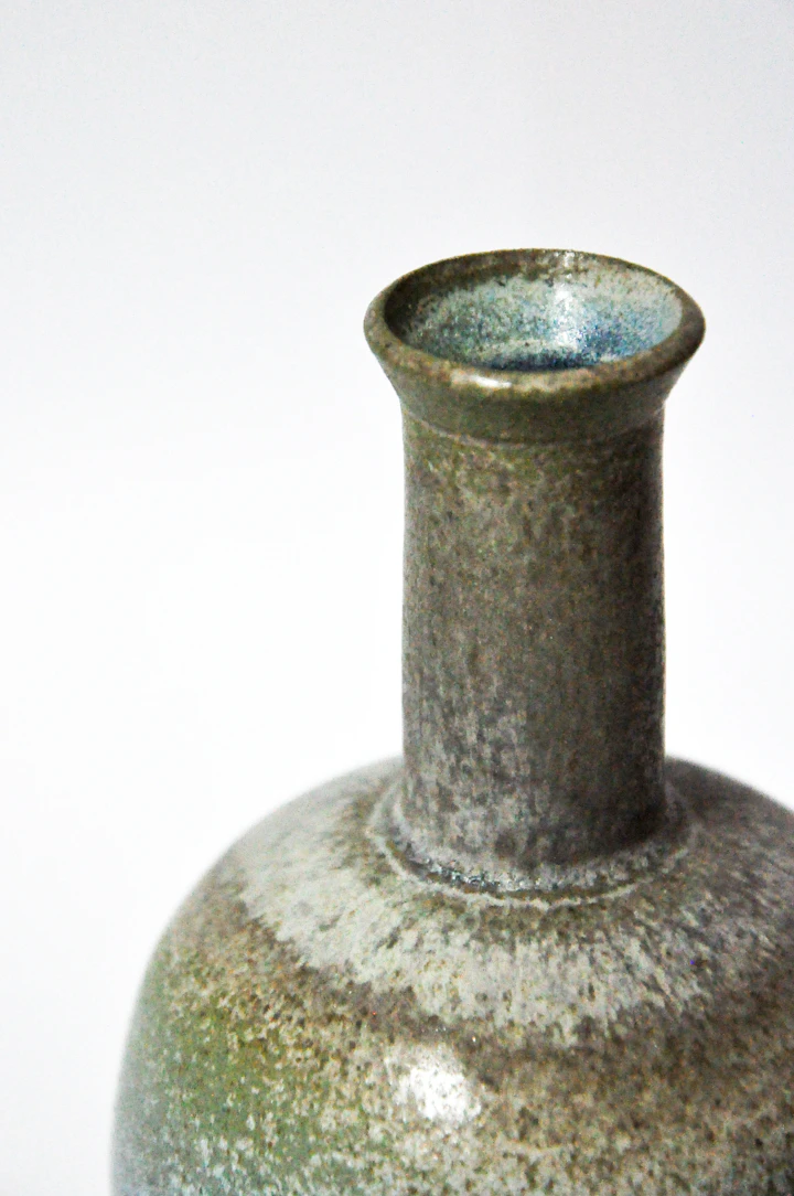 Tall wood-fired bud vase with narrow neck — mottled iron glaze