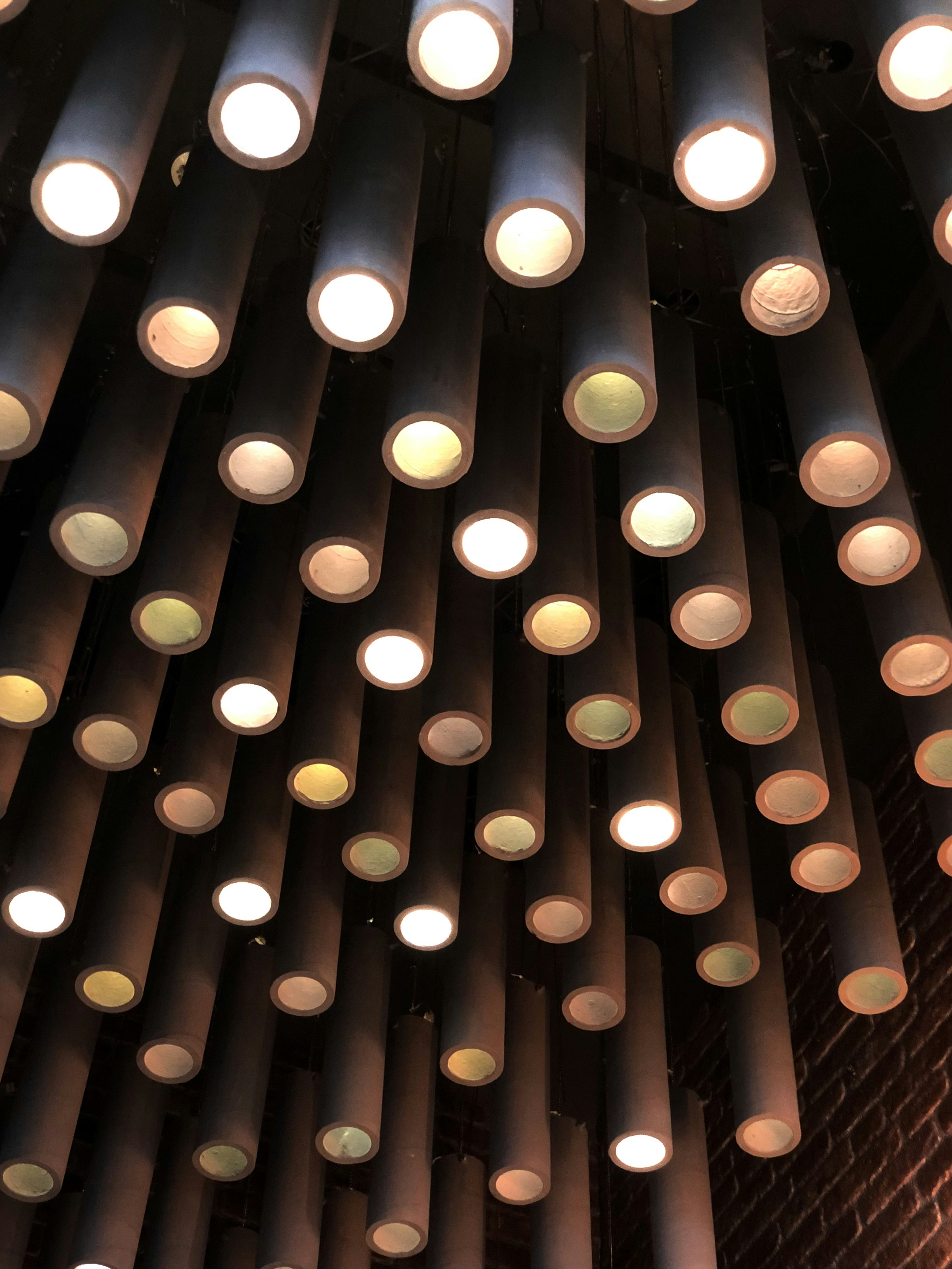 a large pipe with many lights hanging from it