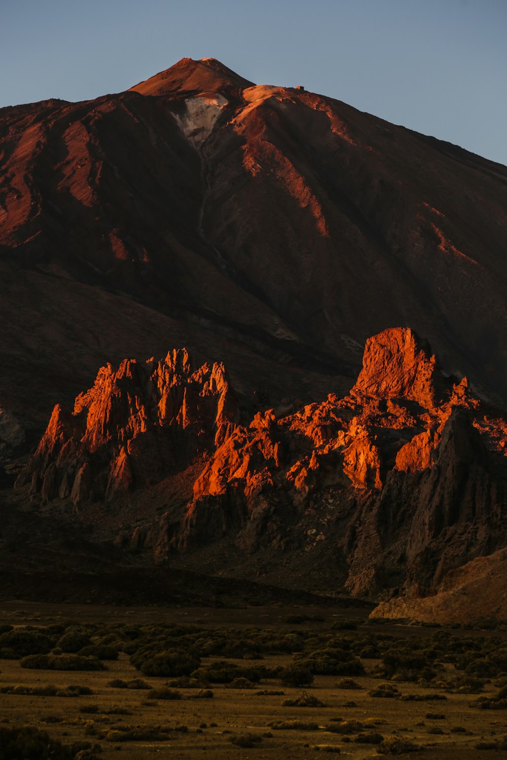 a large mountain with a snow capped peak