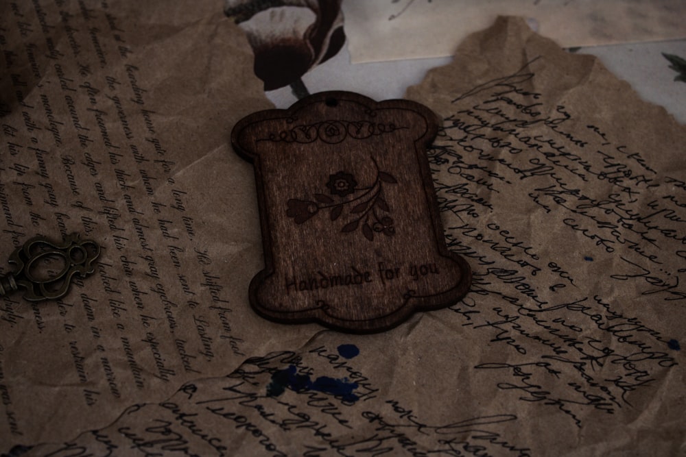 a wooden badge sitting on top of a piece of paper