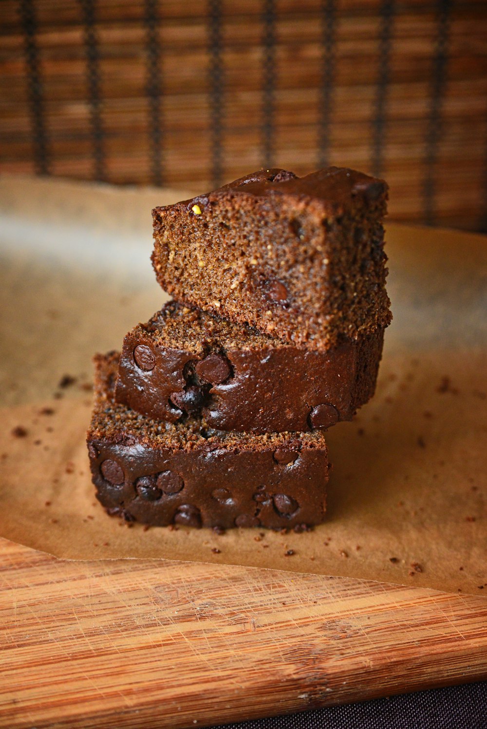 a couple of pieces of chocolate cake sitting on top of a wooden cutting board