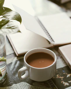 a cup of coffee sitting on top of a table