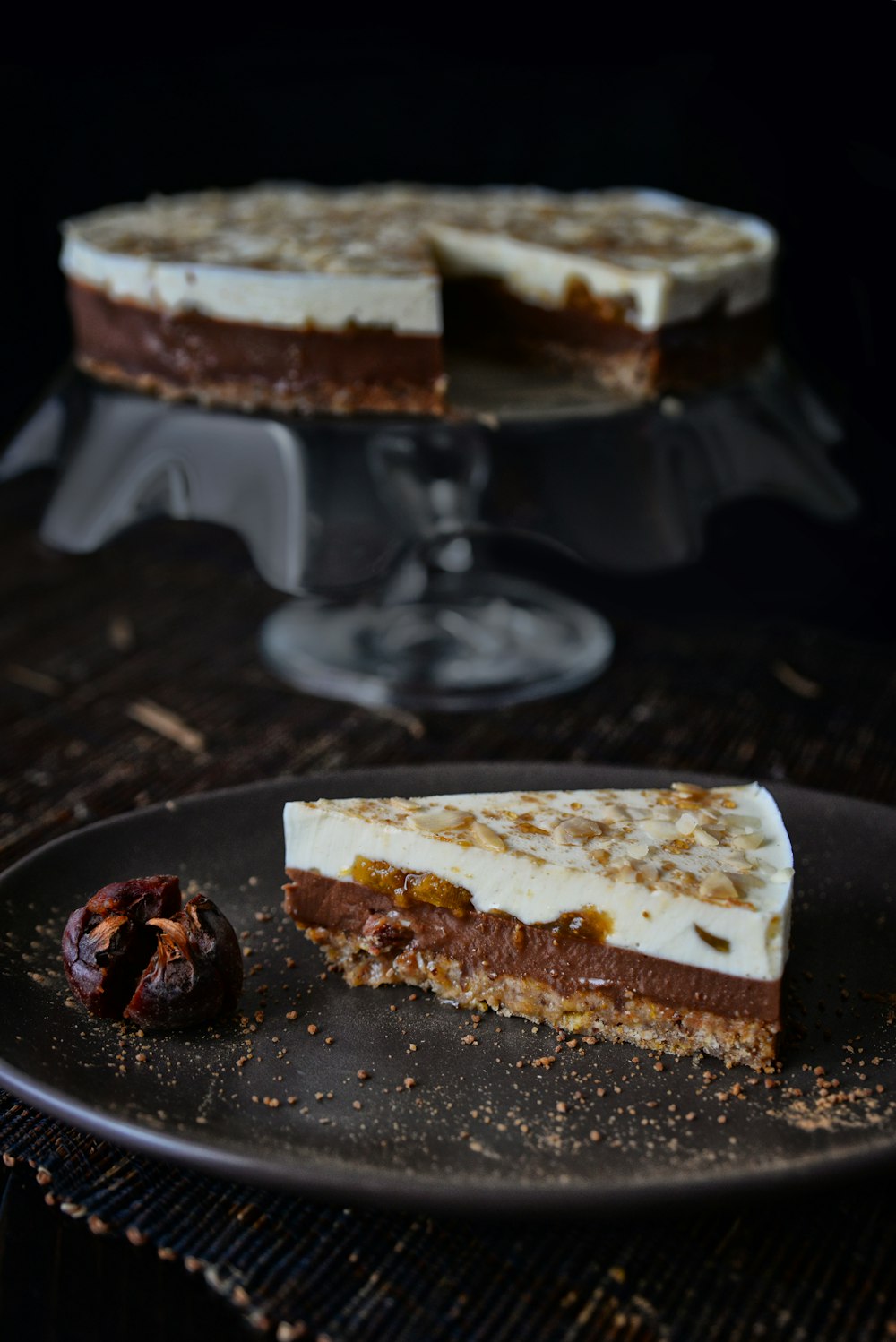 a piece of cake sitting on top of a black plate