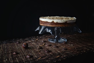 A close-up of a layered chocotorta with chocolate cookies and creamy dulce de leche filling on a rustic wooden table.