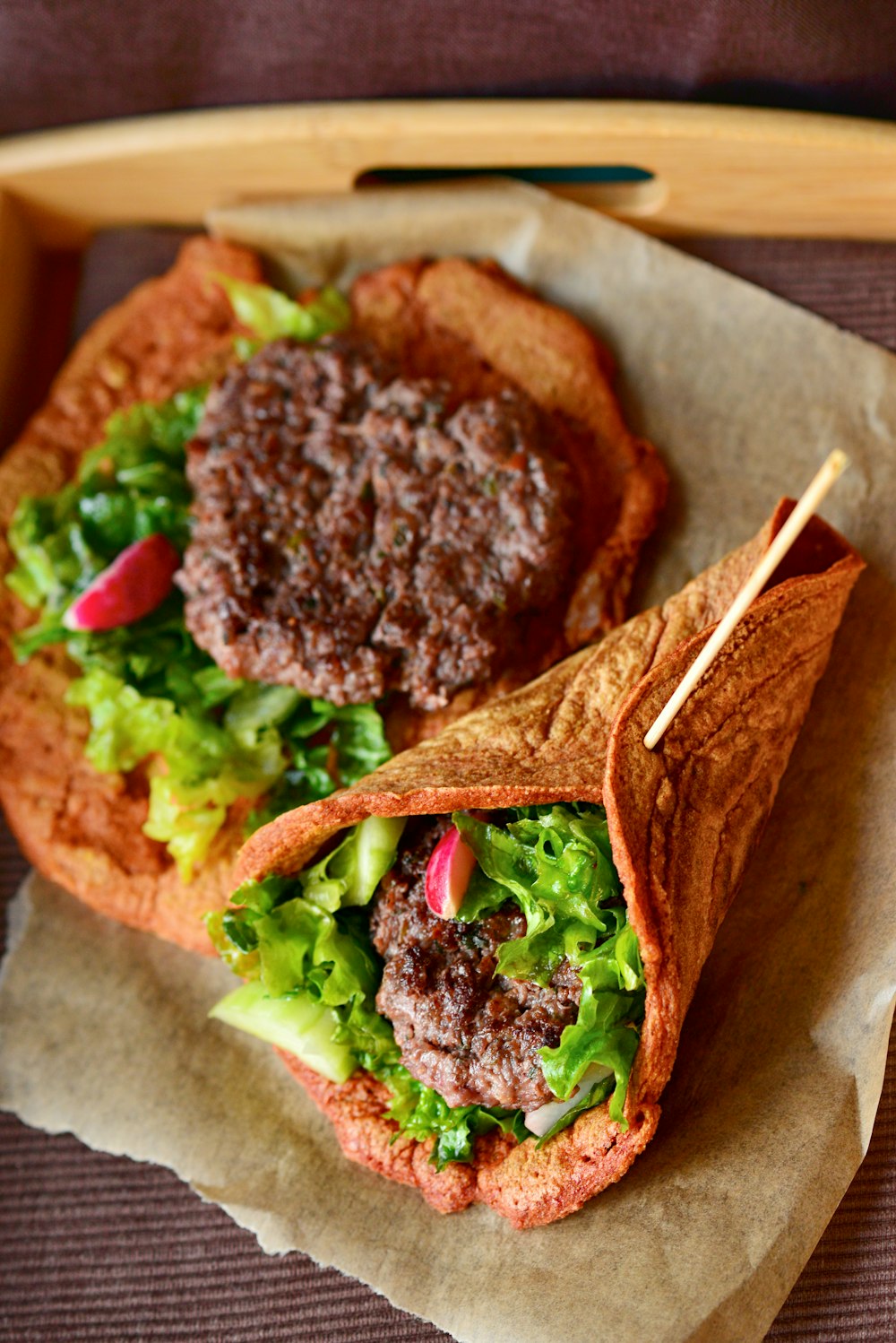 a sandwich with meat and lettuce on a tray