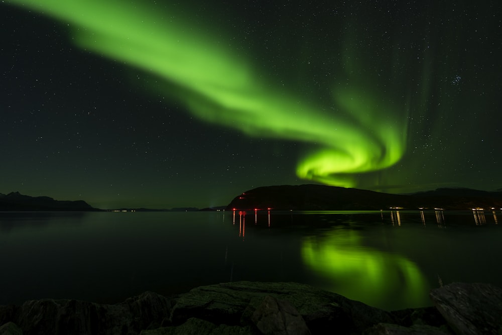 a green aurora bore over a body of water