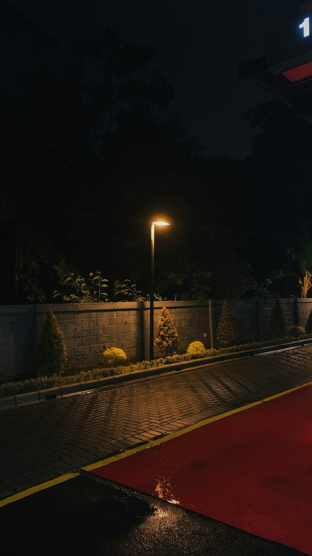 a red carpet on the side of a road at night