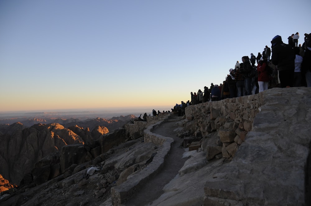 a group of people standing on top of a mountain