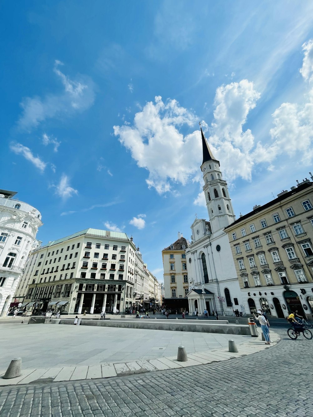 a city square with a clock tower in the middle