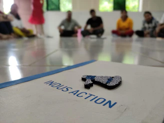 A focused group of diverse individuals gathered around a table, drafting the Indian United Front's foundational documents.