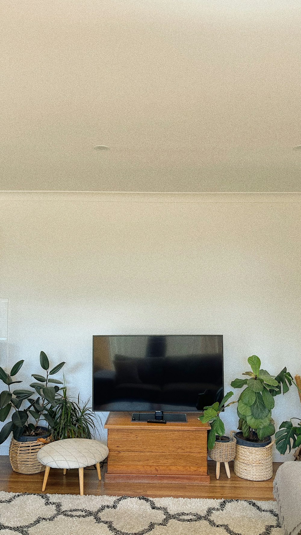 a flat screen tv sitting on top of a wooden stand