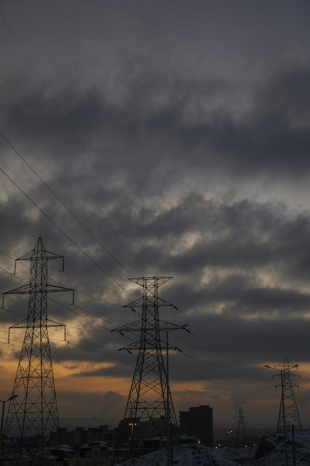 a couple of power lines sitting under a cloudy sky