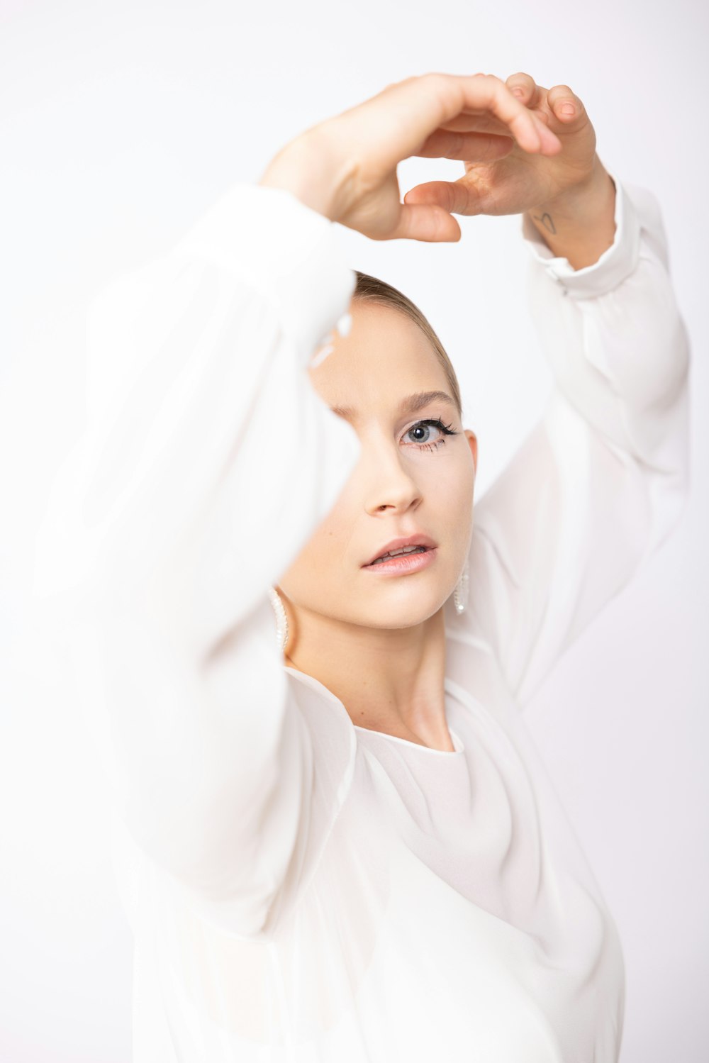 a woman in a white shirt is posing for a picture