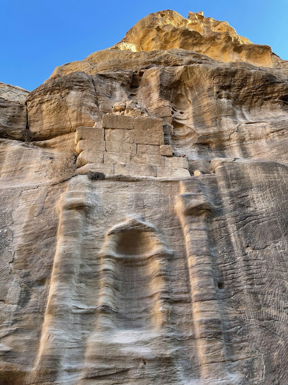 a rock formation with a small cave in the middle of it