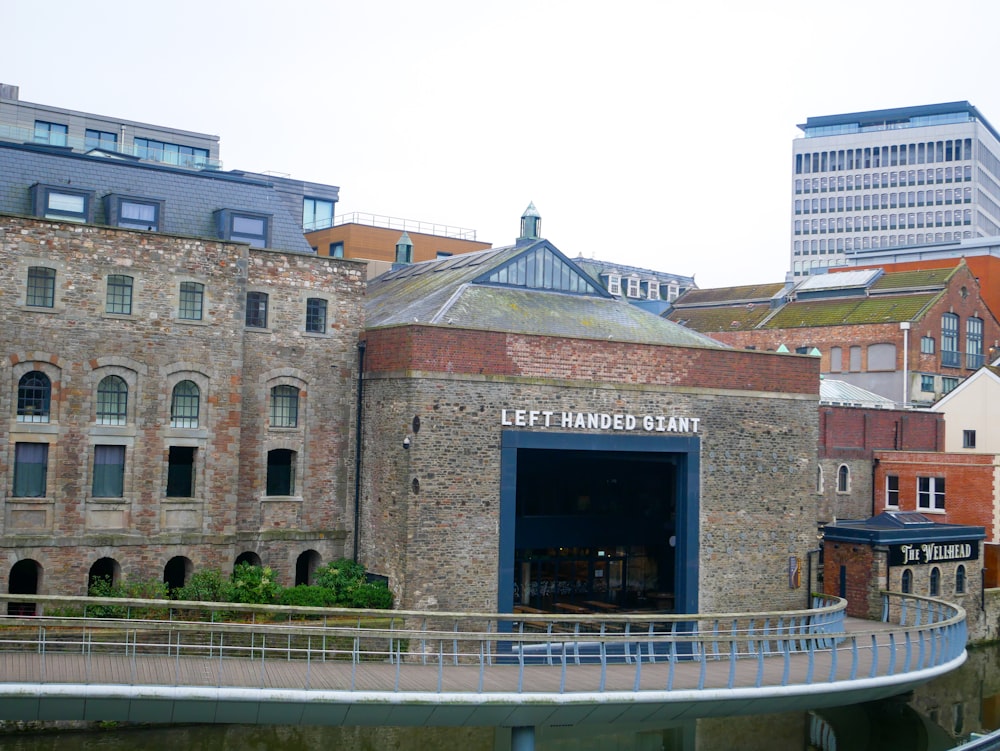an old brick building with a circular walkway in front of it