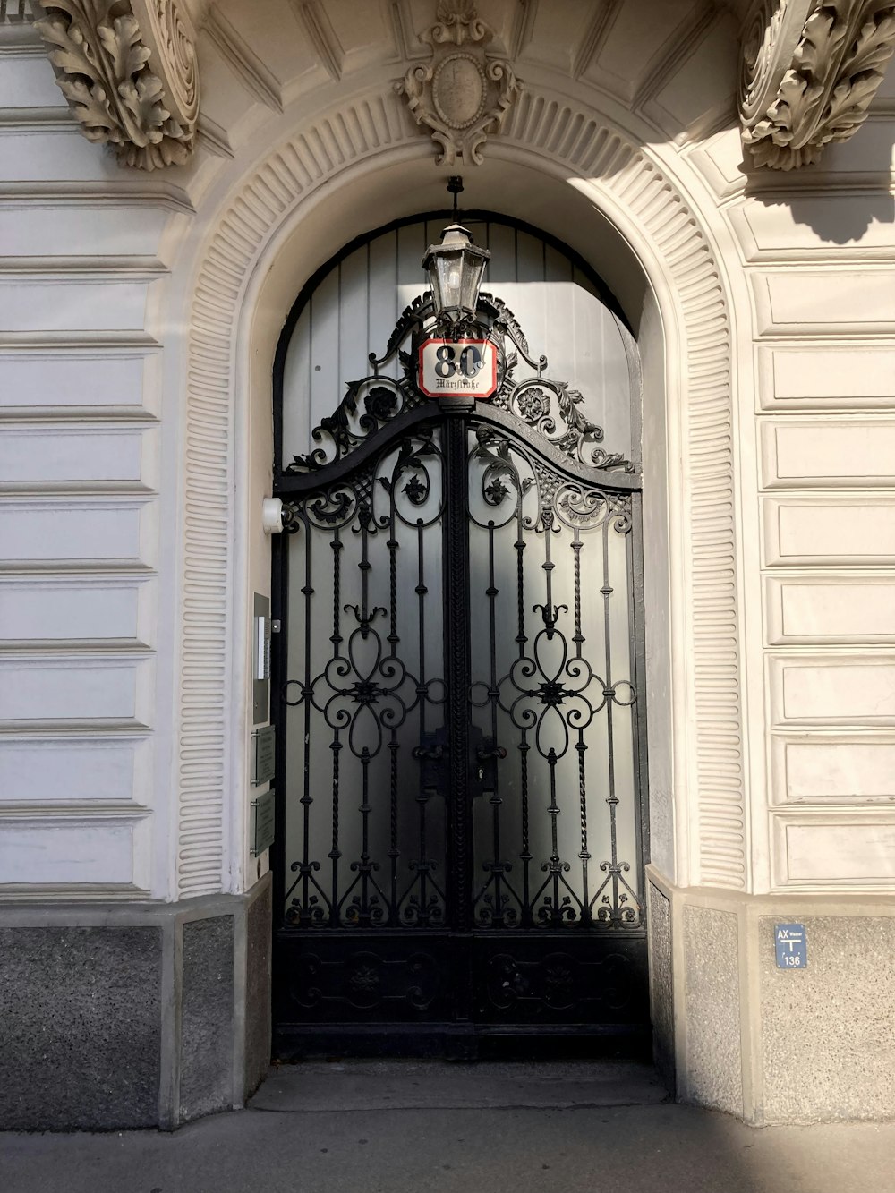 a large black gate with a clock on it