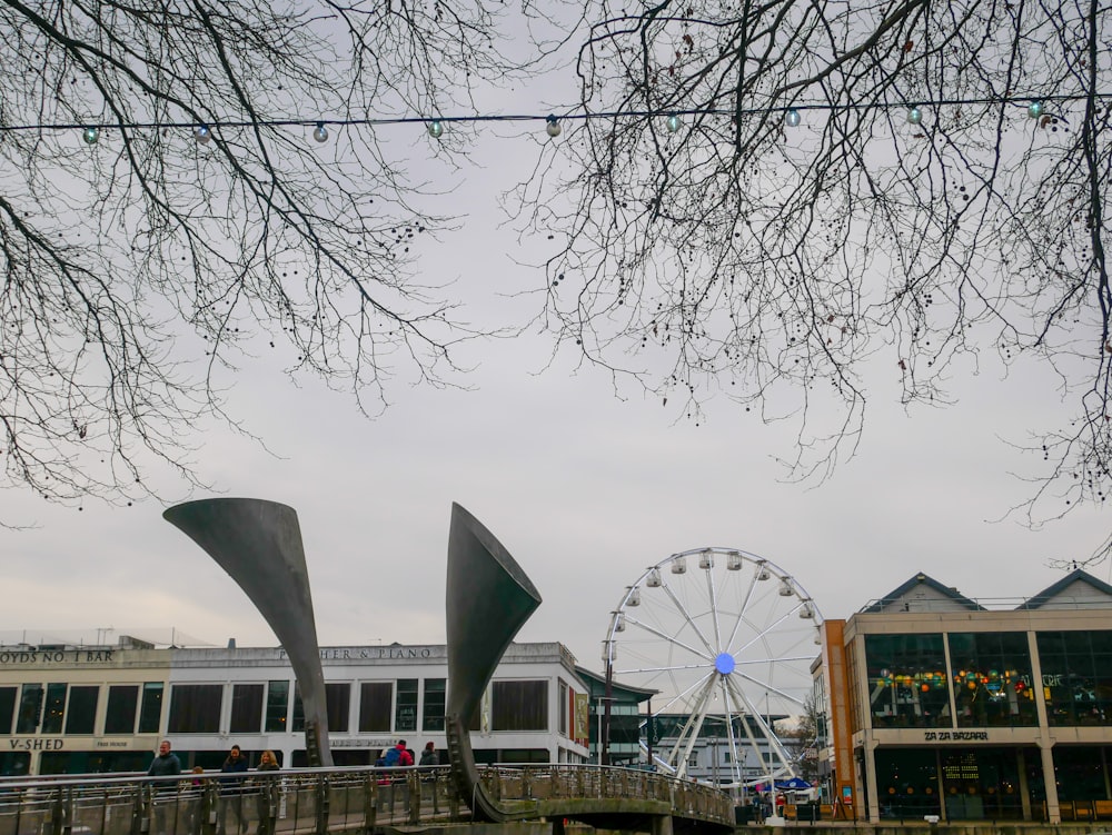 a ferris wheel and a ferris wheel in front of a building