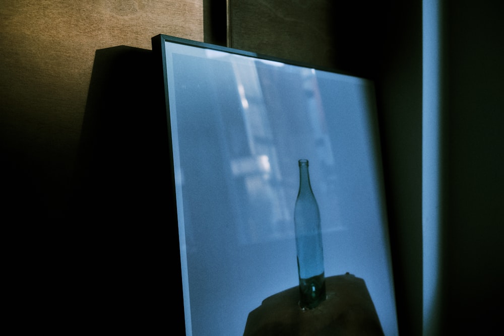 a picture of a glass bottle on a table