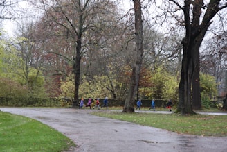 Children running joyfully in a park wearing stylish clothing