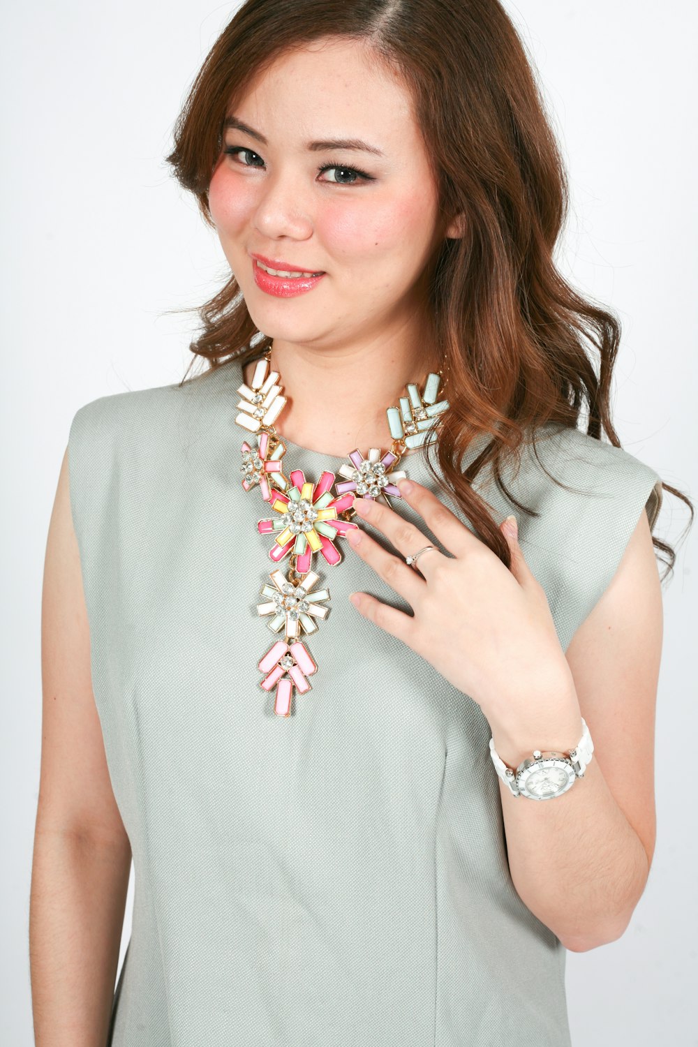 a woman is wearing a necklace and bracelet