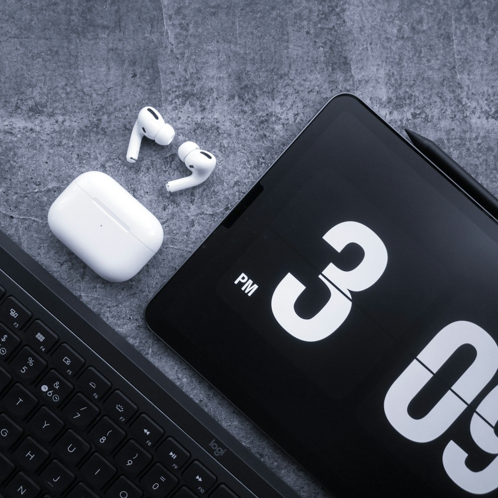 a pair of headphones sitting next to a keyboard