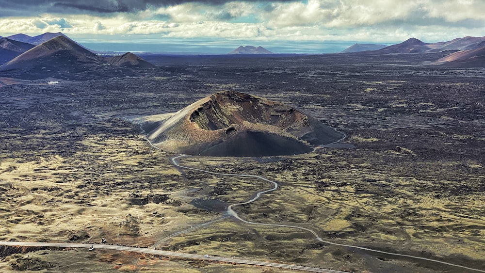 an aerial view of a mountain range with a winding road