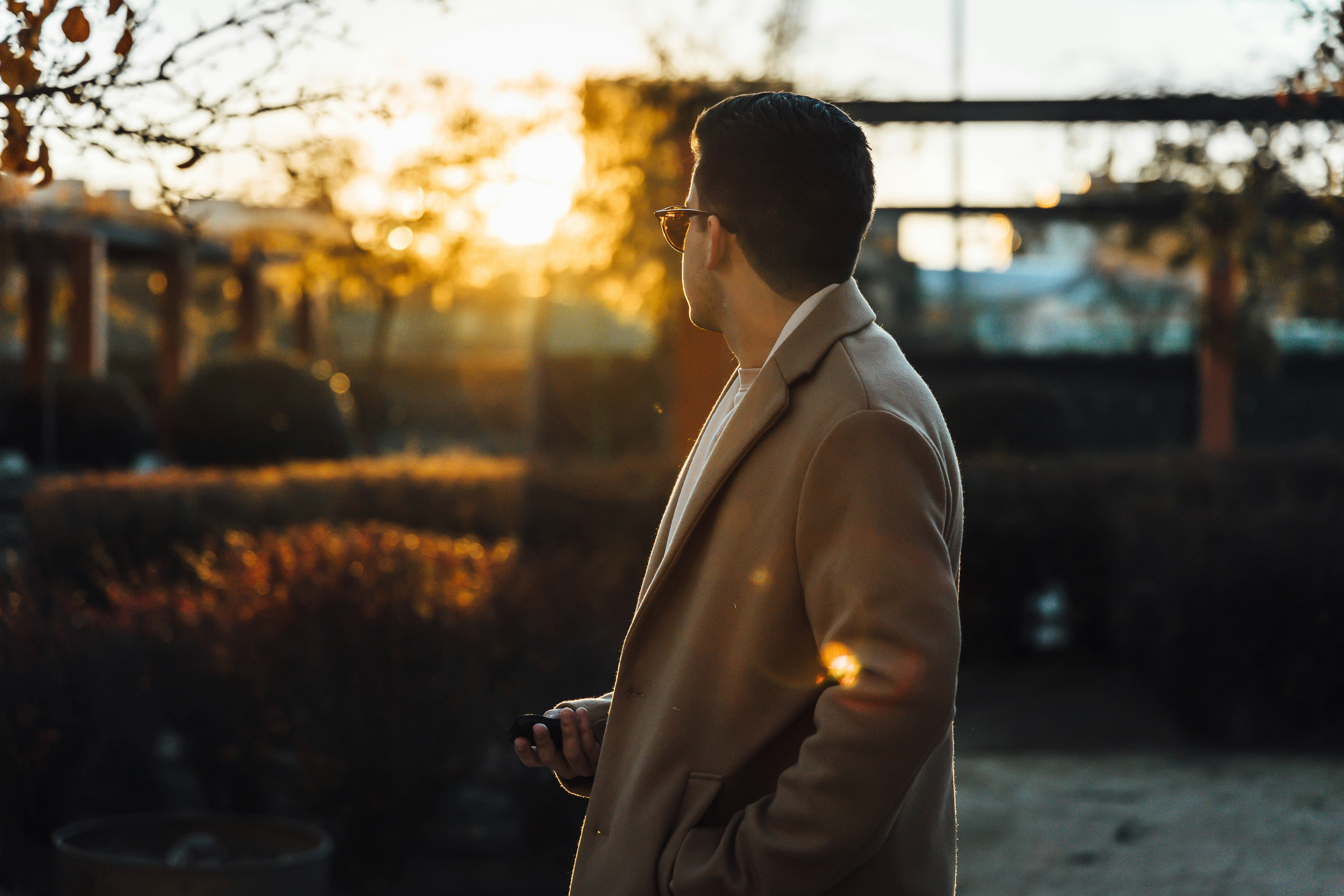 a man in a suit is looking at the sun